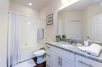 a bathroom with a sink and a toilet and a tub at Corner Villa in West Lucaya – Your Ideal Getaway in Kissimmee