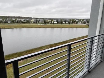 a view of a lake from a balcony at Comfortable 2BR Condo w/ Lake Views in Kissimmee