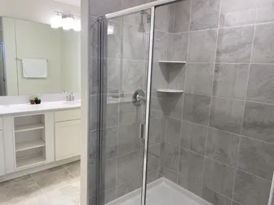 a shower with a glass door in a bathroom at Comfortable 2BR Condo w/ Lake Views in Kissimmee