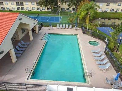 an overhead view of a swimming pool with a tennis court at The Galactic Getaway, 3Bed, 2Bath Apartment, Free Parking, Heated Pool in Kissimmee