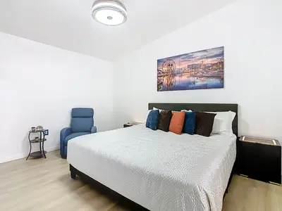 a bedroom with a bed and a blue chair at The Galactic Getaway, 3Bed, 2Bath Apartment, Free Parking, Heated Pool in Kissimmee
