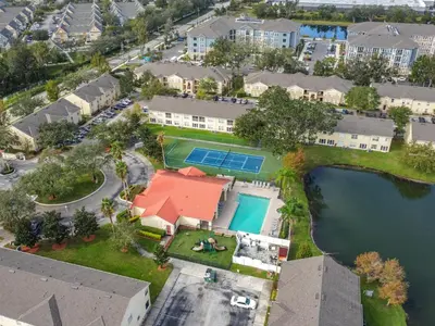 an aerial view of a house with a pool and a yard at The Galactic Getaway, 3Bed, 2Bath Apartment, Free Parking, Heated Pool in Kissimmee