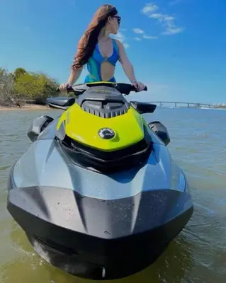 a woman is riding on a jet ski in the water at Large Deck, Lakefront, Yard Games in Orlando