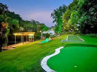 a golf course with a putting green at night at Large Deck, Lakefront, Yard Games in Orlando