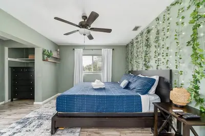 a bedroom with a bed and a ceiling fan at 4 Rooms, Lake, Pool, Hot Tub, Bocce Ball, Putting in Orlando