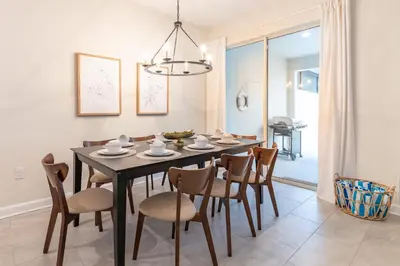 a dining room with a black table and chairs at Beautiful Storey Lake Retreat Minutes from Disney in Kissimmee