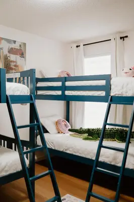 a group of bunk beds in a room at Luxury Private Pool Villa near Disney with Fire Pit, Game Room & More in Kissimmee