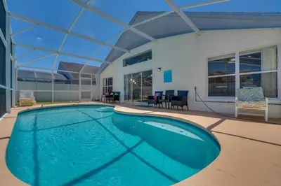 a swimming pool in the middle of a house at 15 Mi to Universal Home with Pool in Kissimmee