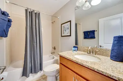 a bathroom with a sink and a toilet and a shower at Private Pool and Game Room Family Vacation Rental in Kissimmee
