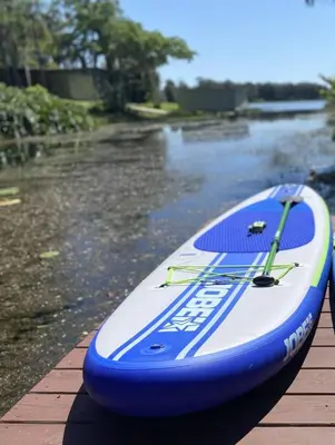 a blue and white surfboard sitting on top of a river at Lakefront Guest House By Downtown, Boat, Fishing in Orlando