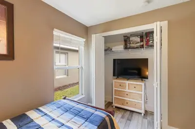 a bedroom with a bed and a dresser and a window at Vacation Home near Disney World! in Kissimmee