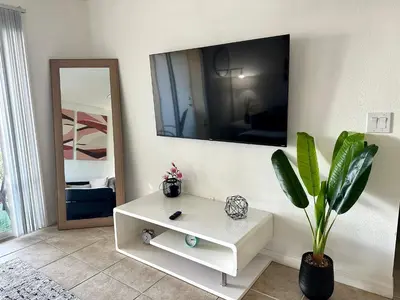 a room with a white table and a mirror at Modern 2BR Lakeview Near Orlando Airport Free Parking in Orlando