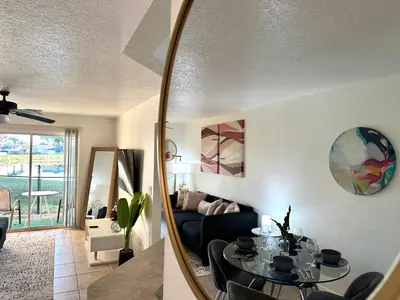 a living room with a table and a couch at Modern 2BR Lakeview Near Orlando Airport Free Parking in Orlando