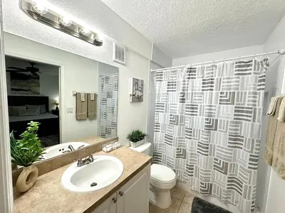 a bathroom with a sink and a toilet and a shower at Modern 2BR Lakeview Near Orlando Airport Free Parking in Orlando