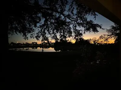 a view of a bridge over a lake at sunset at Modern 2BR Lakeview Near Orlando Airport Free Parking in Orlando