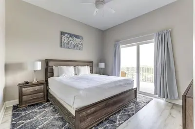 a bedroom with a bed and a large window at Disney Lakefront Luxury! in Orlando