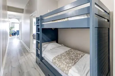 a blue bunk bed in a room with a bed at Disney Lakefront Luxury! in Orlando