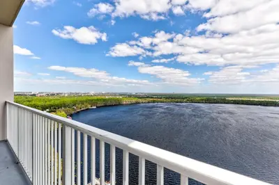 a balcony with a view of a river at Disney Lakefront Luxury! in Orlando