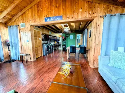 a living room with a couch and a table at Hook's Cabin- Lake & Pool Near Disney A-frame in Clermont