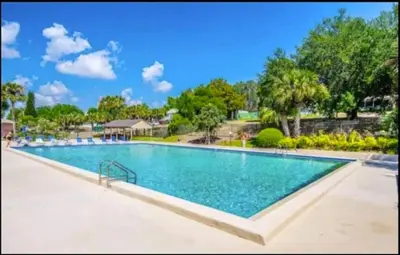 a large swimming pool in a resort at Hook's Cabin- Lake & Pool Near Disney A-frame in Clermont
