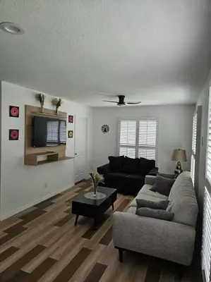 a living room with a couch and a table at Newly Renovated Modern Studio in Oviedo