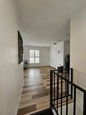 an empty living room with a staircase in a house at Newly Renovated Modern Studio in Oviedo