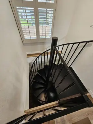 a spiral staircase in a building with a window at Newly Renovated Modern Studio in Oviedo