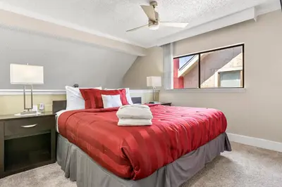 a bedroom with a red bed and a window at Tranquil Haven 2BD 2BA Paradise 10min to Orlando's Best Theme Parks in Orlando