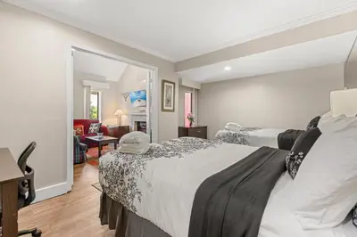 a bedroom with two beds and a living room at Tranquil Haven 2BD 2BA Paradise 10min to Orlando's Best Theme Parks in Orlando