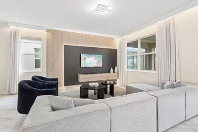 a living room with a couch and chairs and a tv at 4561 Majestic 9BD Kingdom Retreat Near Disney in Kissimmee