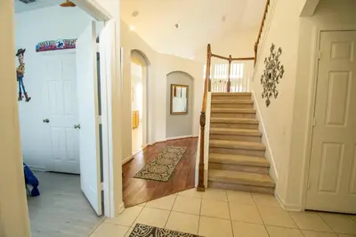 a hallway with a staircase in a home at Stunning 6 bedroom vacation villa in Orlando
