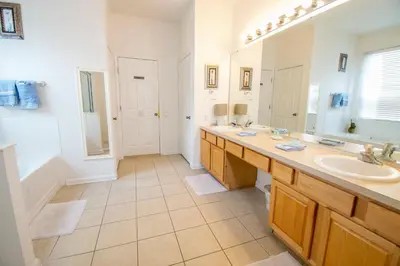 a bathroom with a sink and a large mirror at Stunning 6 bedroom vacation villa in Orlando