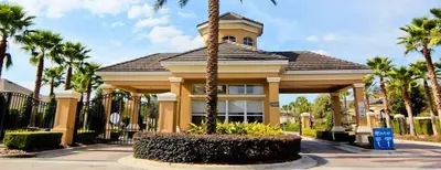 a building with a palm tree in front of it at Stunning 6 bedroom vacation villa in Orlando