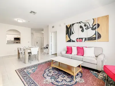 a living room with a couch and a table at Windsor Hills Luxury Condo, Pool,Slides, By Disney in Orlando