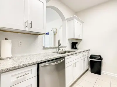 a kitchen with white cabinets and a sink at Windsor Hills Luxury Condo, Pool,Slides, By Disney in Orlando