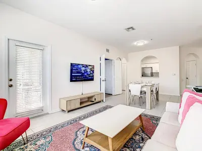 a living room with a couch and a table at Windsor Hills Luxury Condo, Pool,Slides, By Disney in Orlando