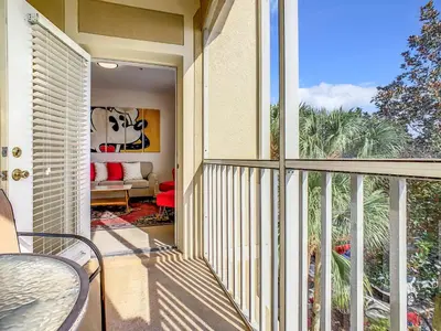 an open balcony with a table and chairs on a patio at Windsor Hills Luxury Condo, Pool,Slides, By Disney in Orlando