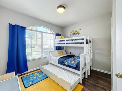 a bedroom with a white bunk bed and a window at Windsor Palms Minion, Princess, Mickey, Pool Home in Kissimmee