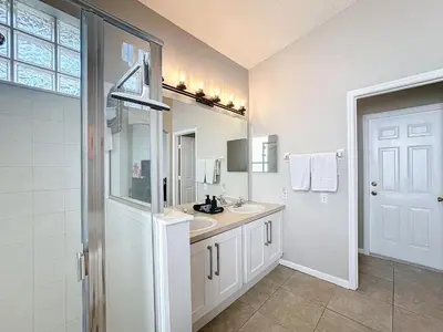 a white bathroom with a sink and a shower at Windsor Palms Minion, Princess, Mickey, Pool Home in Kissimmee