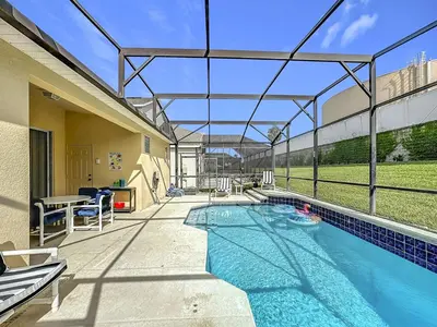 a swimming pool in a house with a glass roof at Windsor Palms Minion, Princess, Mickey, Pool Home in Kissimmee