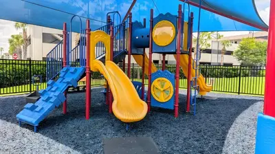 a playground with a slide in a park at Updated 3BR Condo near Convention Center & Epic in Orlando