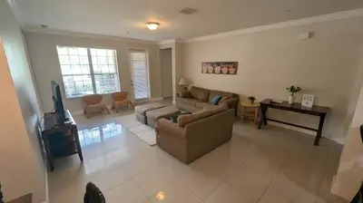 a living room with a couch and a table at Updated 3BR Condo near Convention Center & Epic in Orlando