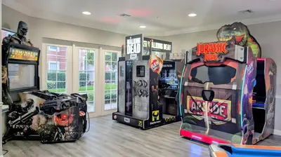 a room with arcade games and video games at Updated 3BR Condo near Convention Center & Epic in Orlando