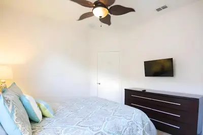 a bedroom with a bed and a ceiling fan at Free Water Park 4BR wPool Game Room 7739TB in Orlando