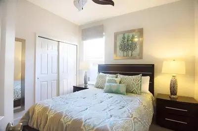 a bedroom with a large bed and a window at Free Water Park 4BR wPool Game Room 7739TB in Orlando