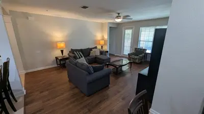 a living room with a couch and a table at 2BR Condo close Convention Center l Epic in Orlando