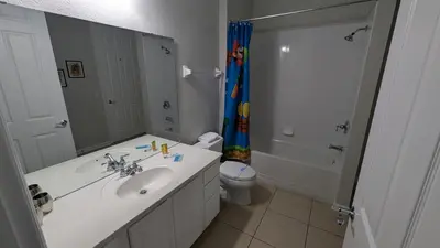 a bathroom with a sink and a toilet and a shower at 2BR Condo close Convention Center l Epic in Orlando