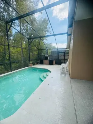 a swimming pool in a building with a large window at Family Dream Home Near Disney in Kissimmee