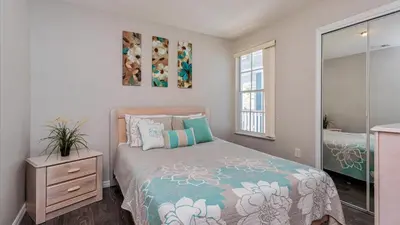 a bedroom with a bed and a window at Villas At Island Club Community, Pools, Jacuzzi And More! in Kissimmee