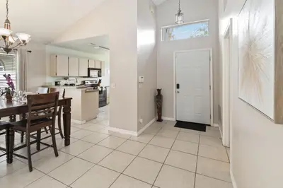 a kitchen and dining room with a table and chairs at Cozy Home Near Disney!!! in Kissimmee